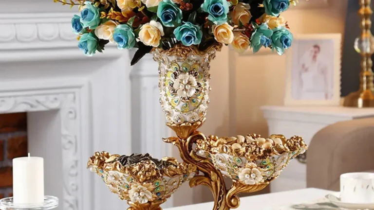 Shinely 2-tier gold and white resin fruit basket tray with decorative vase, featuring a luxury modern design and stable carved base, displayed with fruits and snacks.